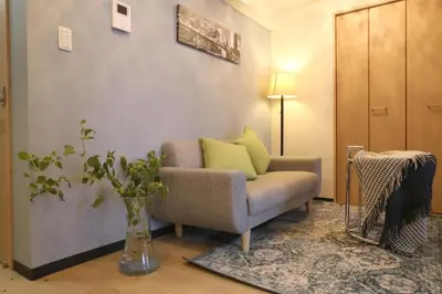 a living room with a couch and a vase with green pillows at Ikebukuro area 6mins from sta Max6 2 bedrooms N202 in Tokyo