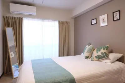 a bedroom with a large bed and a window at Ikebukuro area 6mins from sta Max6 2 bedrooms N202 in Tokyo