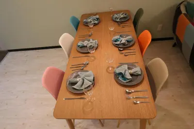 a wooden table with plates and utensils on it at Maple & Ginkgo Views Autumn Stay Up To 9 N201 in Tokyo