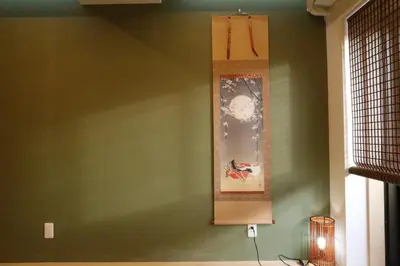 a painting on a green wall in a room at Maple & Ginkgo Views Autumn Stay Up To 9 N201 in Tokyo
