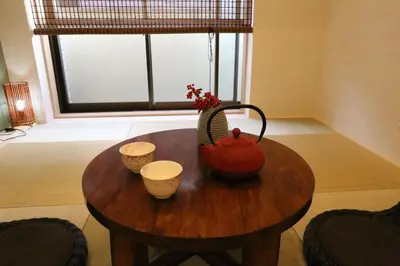 a table with a tea pot and two cups on it at Maple & Ginkgo Views Autumn Stay Up To 9 N201 in Tokyo