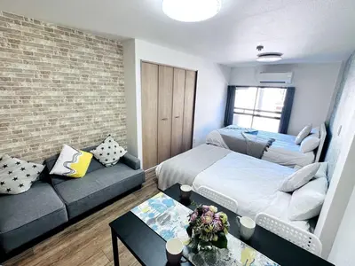 a small living room with a couch and a bed at M205 8 mins from Ikebukuro sta 9 min to Shinjuku by Train in Tokyo