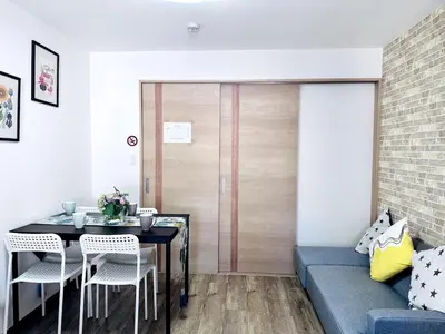 a living room with a table and a couch at M205 8 mins from Ikebukuro sta 9 min to Shinjuku by Train in Tokyo