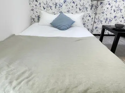 a bed with a blue pillow on top of it at Ikebukuro area6mins from staMax4 2 double beds \u5357\u9577\u5d0e101 in Tokyo