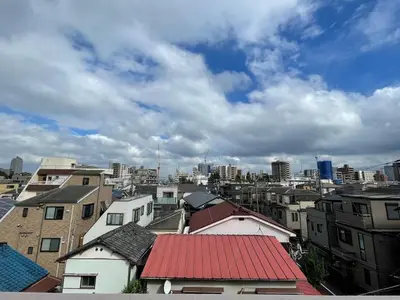 a view of a city with buildings and a cloudy sky at Ikebukuro area6mins from staMax6 2 bedrooms\u5357\u9577\u5d0e401 in Tokyo