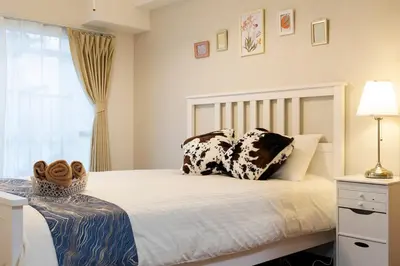 a bedroom with a bed with pillows on it at Maple & Ginkgo ViewsAutumn Stay Near Ikebukuro N102 in Tokyo