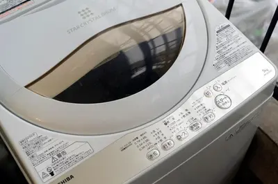 a white washing machine sitting on top of a counter at Maple & Ginkgo ViewsAutumn Stay Near Ikebukuro N102 in Tokyo