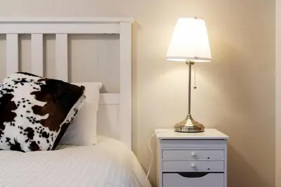 a lamp on a night stand next to a bed at Maple & Ginkgo ViewsAutumn Stay Near Ikebukuro N102 in Tokyo