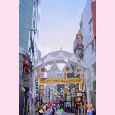 a group of people walking around a street in a city at Maple & Ginkgo ViewsAutumn Stay Near Ikebukuro N102 in Tokyo