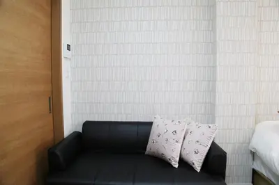 a black leather couch with two pillows in a bedroom at Easy access to Ikebukuro Red Leaves ,Golden GinkgoM303 in Tokyo
