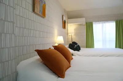 a hotel room with two beds and a window at Easy access to Ikebukuro Red Leaves ,Golden GinkgoM303 in Tokyo