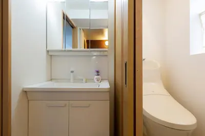 a bathroom with a sink and a toilet and a mirror at Maple & Ginkgo ViewsAutumn Stay Near Ikebukuro N303 in Tokyo