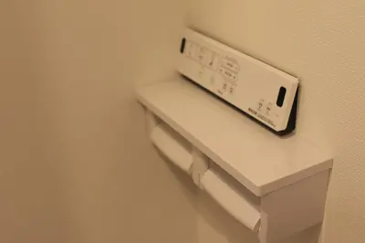 a clock on a shelf in a hotel room at Maple & Ginkgo ViewsAutumn Stay Near Ikebukuro N303 in Tokyo