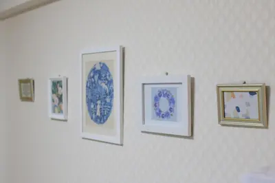 a group of framed pictures on a wall at Maple & Ginkgo ViewsAutumn Stay Near Ikebukuro N303 in Tokyo