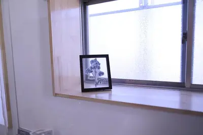 a picture in a frame sitting on a window sill at Maple & Ginkgo ViewAutumn Stay Near Ikebukuro N203 in Tokyo
