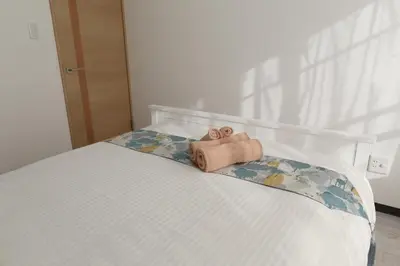 a towel sitting on a bed in a bedroom at Maple & Ginkgo ViewAutumn Stay Near Ikebukuro N203 in Tokyo