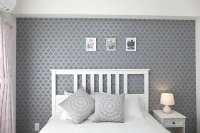a bedroom with a white bed with a gray wall at Maple & Ginkgo ViewAutumn Stay Near Ikebukuro N203 in Tokyo