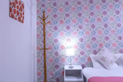 a bedroom with a patterned wall with a bed and a lamp at Maple & Ginkgo ViewsAutumn Stay Near Ikebukuro N105 in Tokyo