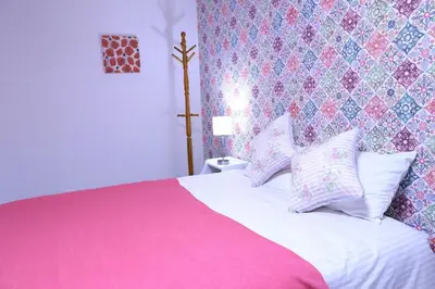 a bedroom with a pink and white bed with pillows at Maple & Ginkgo ViewsAutumn Stay Near Ikebukuro N105 in Tokyo