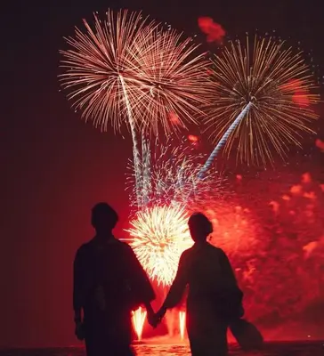 two people standing in front of a fireworks display at Maple & Ginkgo ViewsAutumn Stay Near Ikebukuro N105 in Tokyo