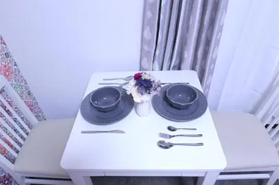 a white table with two plates and flowers on it at Maple & Ginkgo ViewsAutumn Stay Near Ikebukuro N105 in Tokyo