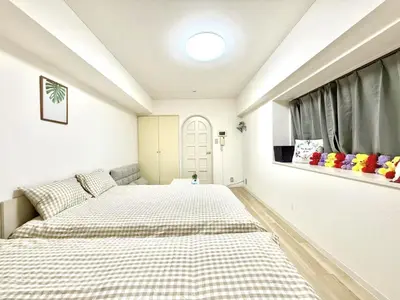 a bedroom with two beds and a window at \u6c60\u888b Bodo House 9 A5 in Tokyo
