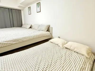 two beds sitting next to each other in a room at \u6c60\u888b Bodo House 9 A5 in Tokyo