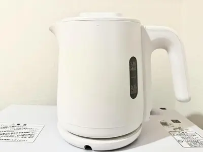 a white electric kettle sitting on top of a counter at \u6c60\u888b Bodo House 9 A5 in Tokyo