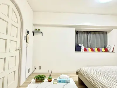a white bedroom with a bed and a window at \u6c60\u888b Bodo House 9 A5 in Tokyo