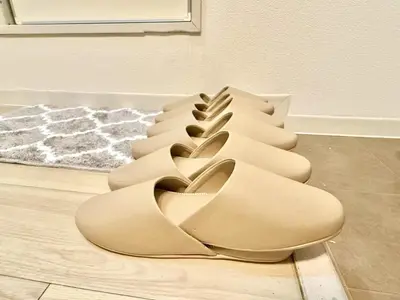 a pair of tan shoes sitting on a floor at \u6c60\u888b Bodo House 9 A5 in Tokyo