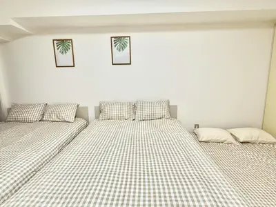 two beds sitting next to each other in a bedroom at \u6c60\u888b Bodo House 9 A5 in Tokyo