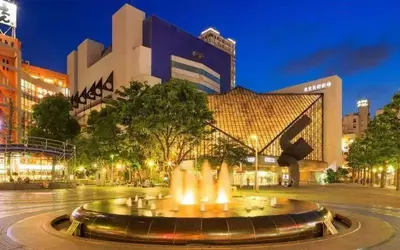 a fountain in the middle of a city at night at \u6c60\u888b Bodo House 9 A5 in Tokyo