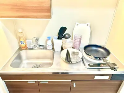 a kitchen counter with a sink and utensils at \u6c60\u888b Bodo House 9 A5 in Tokyo