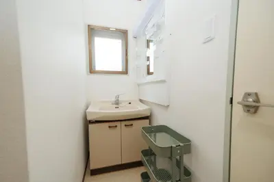 a small bathroom with a sink and a mirror at Cruise Inn Takenotsuka in Tokyo