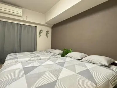 a bedroom with two beds with pillows at \u6c60\u888b IVY House B C 2 in Tokyo