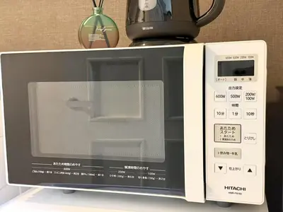 a microwave oven with a coffee pot on top of it at \u6c60\u888b IVY House B C 2 in Tokyo