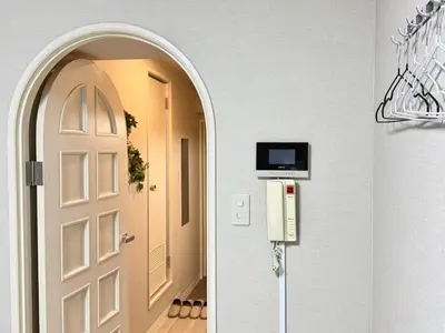 an entrance to a hallway with a door and a television at \u6c60\u888b IVY House B C 2 in Tokyo