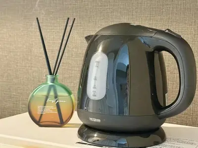 a tea kettle and a vase on a table at \u6c60\u888b IVY House B C 2 in Tokyo
