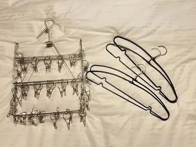 two metal hoses sitting on top of a bed at Tiare Home MOTOHASUNUMA in Tokyo