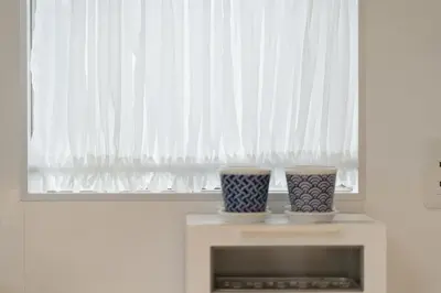 two vases sitting on a shelf in front of a window at K06 Quiet 2LDK house on JR Yamanote Line Komagome Station in Tokyo