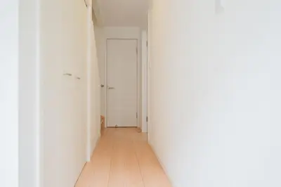 an empty hallway with a white door and a wooden floor at K06 Quiet 2LDK house on JR Yamanote Line Komagome Station in Tokyo