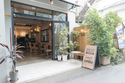 a sign in front of a restaurant with plants at K06 Quiet 2LDK house on JR Yamanote Line Komagome Station in Tokyo