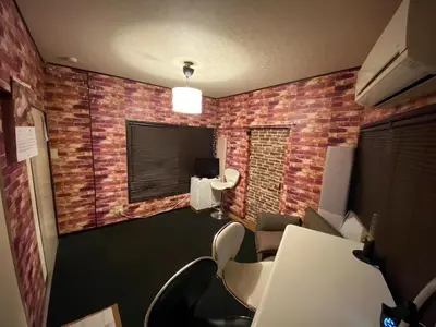 an office with a brick wall with chairs and a desk at Popular Direct from the airport, perfect for getting anywhere in Tokyo, Skytree, Asakusa's best access private lodging Lcuky Smile in Tokyo