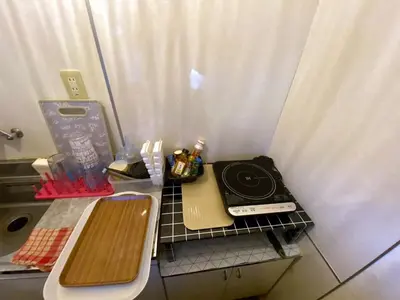 a kitchen with a stove and a counter top at Popular Direct from the airport, perfect for getting anywhere in Tokyo, Skytree, Asakusa's best access private lodging Lcuky Smile in Tokyo