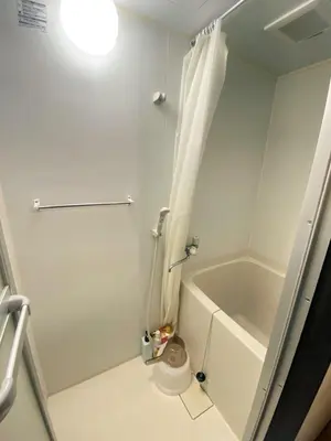 a white bathroom with a tub and a shower at Popular Direct from the airport, perfect for getting anywhere in Tokyo, Skytree, Asakusa's best access private lodging Lcuky Smile in Tokyo