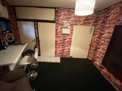 a room with a brick wall and a bathroom with a sink at Popular Direct from the airport, perfect for getting anywhere in Tokyo, Skytree, Asakusa's best access private lodging Lcuky Smile in Tokyo
