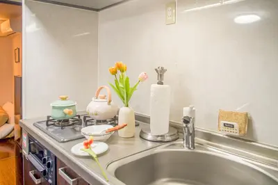 a kitchen sink with vases and flowers on a counter at Ikebukuro mansion,4-6people,two bedrooms,subway 5mins in Tokyo
