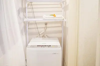 a laundry room with a washer and dryer at Ikebukuro mansion,4-6people,two bedrooms,subway 5mins in Tokyo