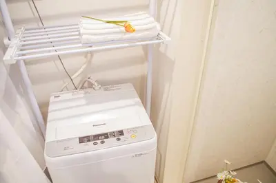 a washer and dryer in a small refrigerator at Ikebukuro mansion,4-6people,two bedrooms,subway 5mins in Tokyo