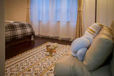 a living room with a couch with a teddy bear on it at Ikebukuro mansion,4-6people,two bedrooms,subway 5mins in Tokyo